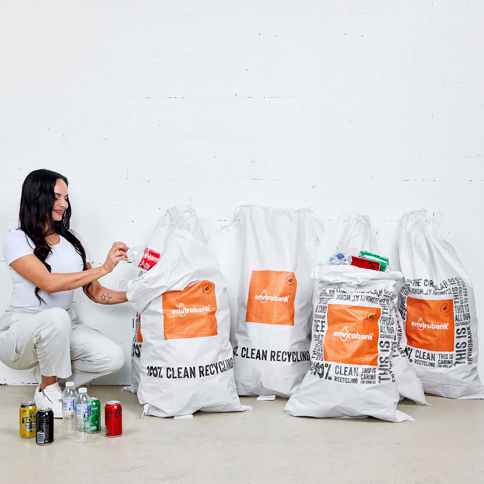 Putting 10c bottle and can recycling into Envirobank white UV bags